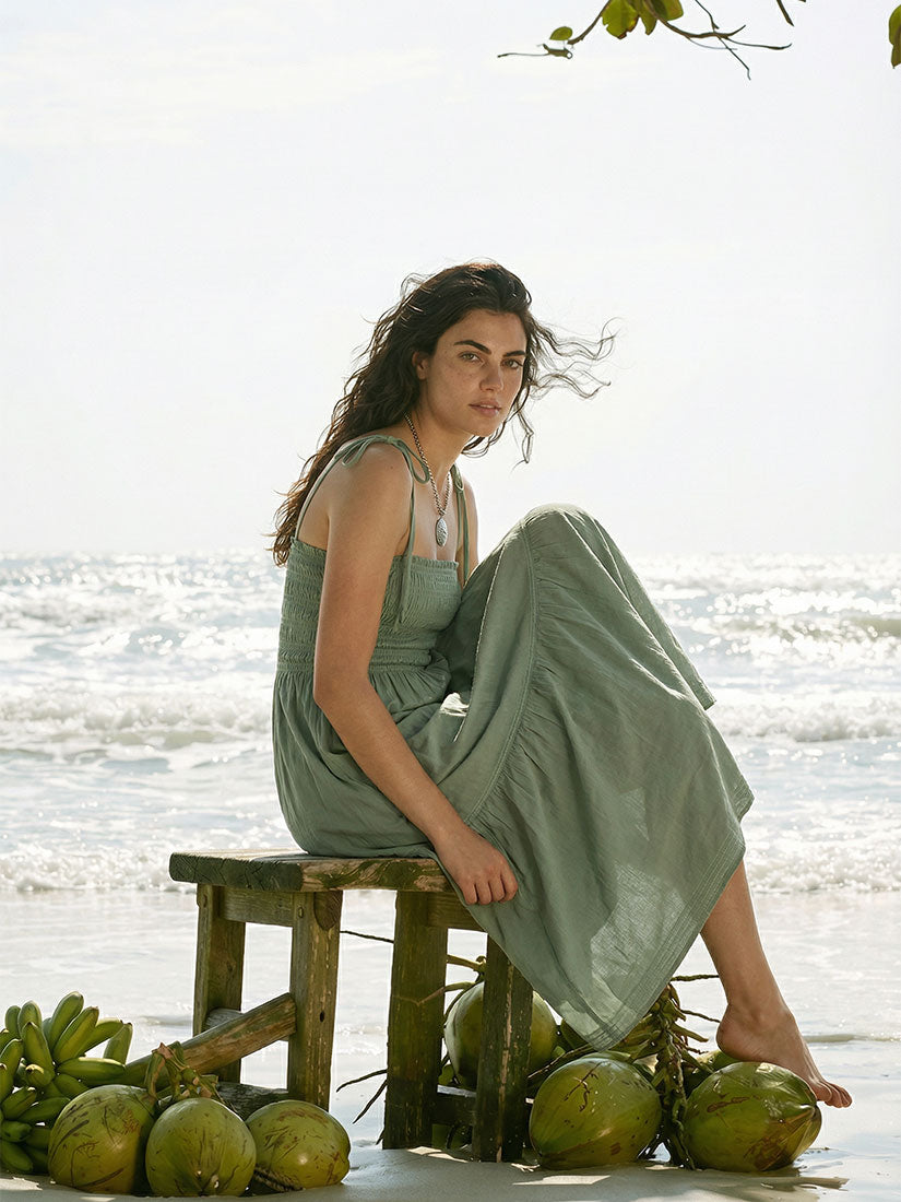 adley maxi from omika on dark haired model at beach with coconuts