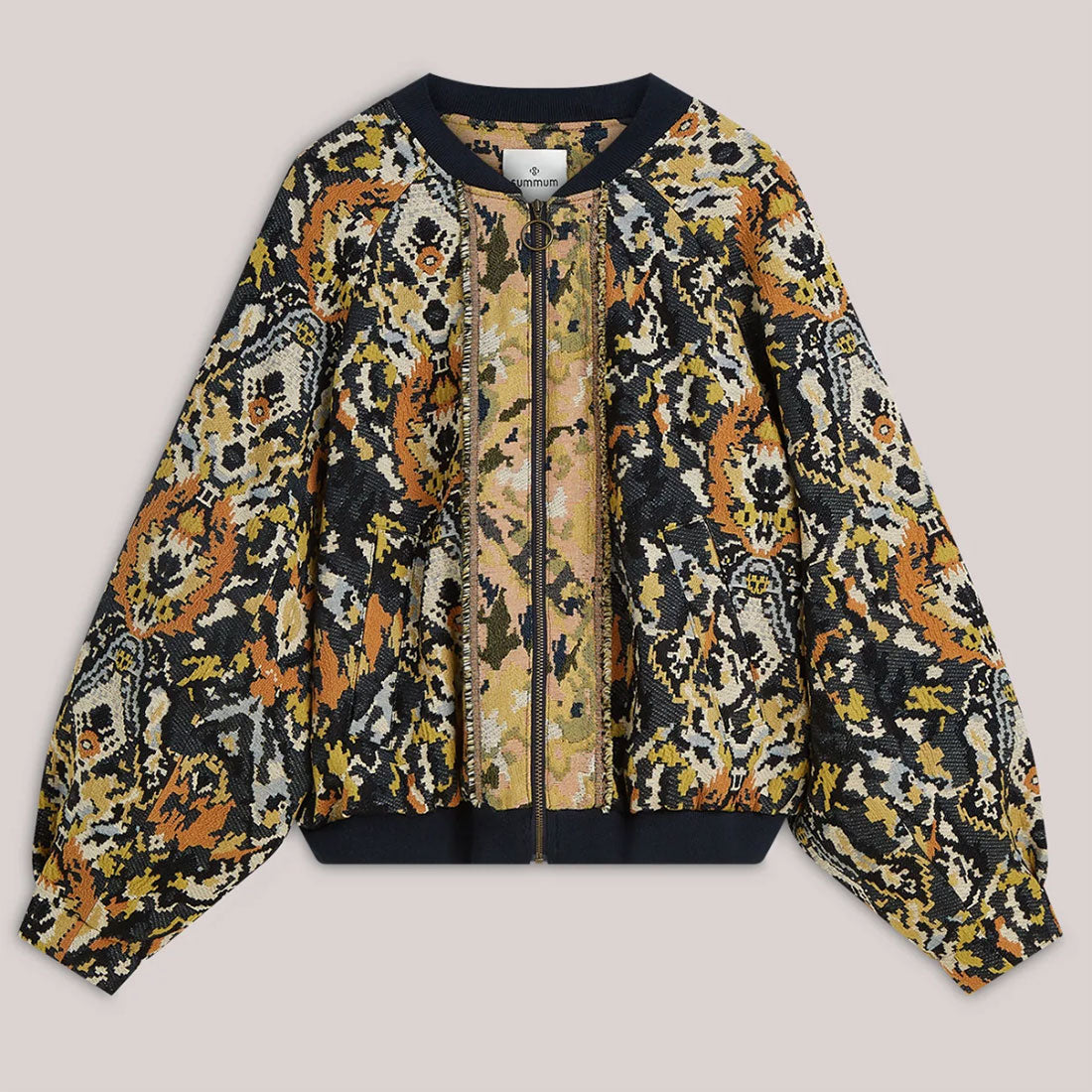 A long-sleeve bomber jacket featuring a complex, multi-colored abstract pattern in black, orange, beige, and yellow, with solid navy ribbed trim at the collar, cuffs, and hem.