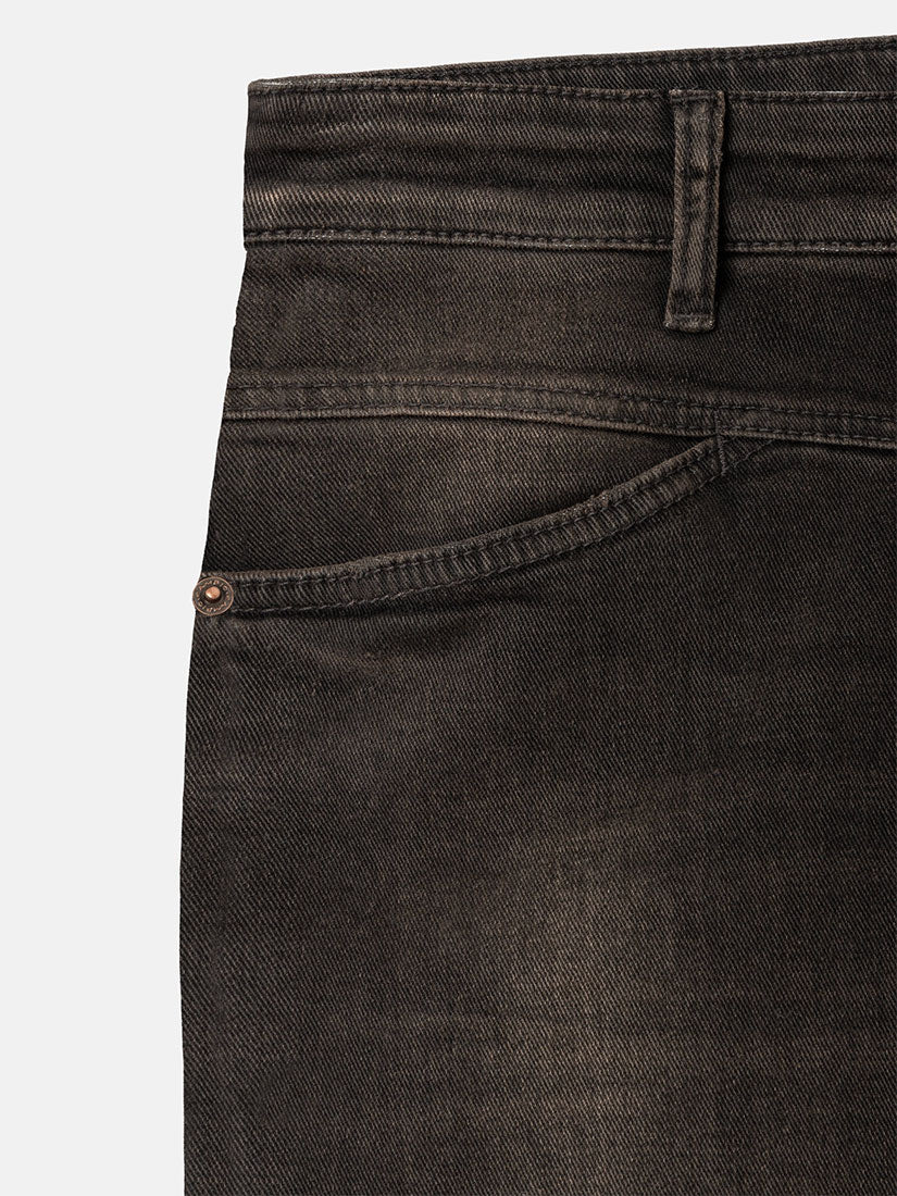 Close-up of dark charcoal gray denim jeans showing the waistband, belt loop, and side pocket with a copper-toned rivet on a light gray background.