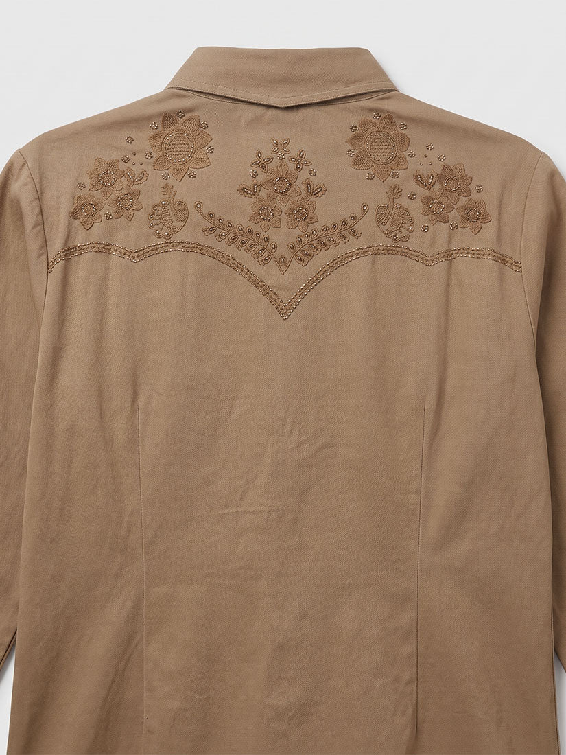 A tan western-style shirt jacket shown from the back, featuring detailed floral embroidery across the upper back and shoulders.