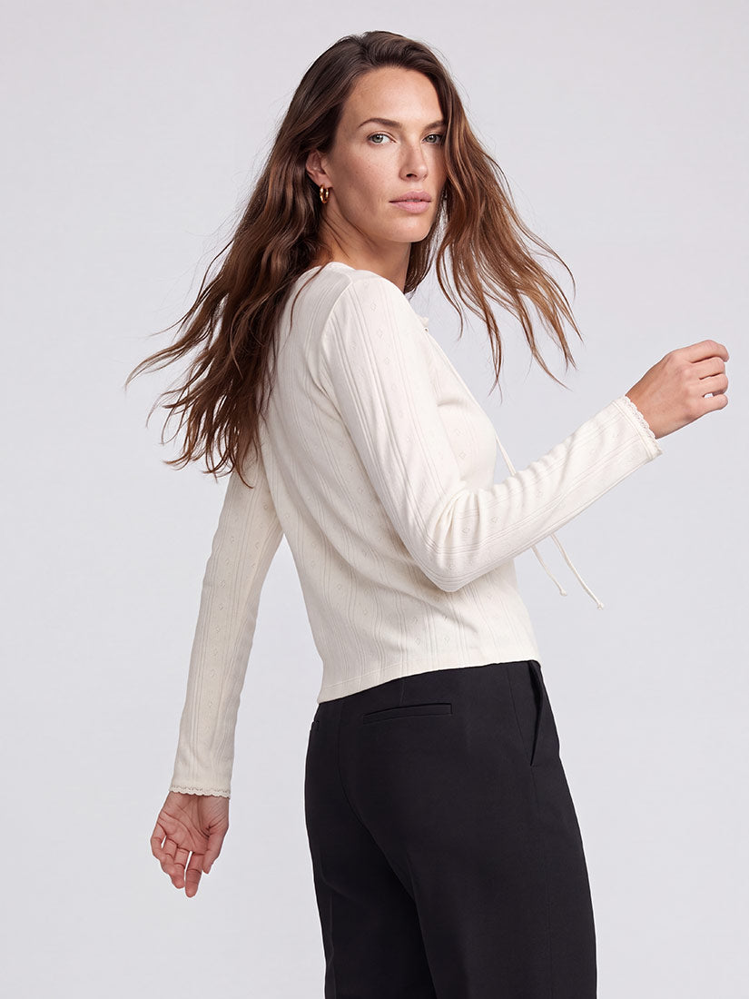 women with red hair facing back in off white tee