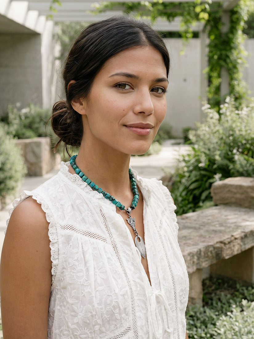 paula carvalho wisdom chunky turquoise necklace with silver pendant on dark haired woman
